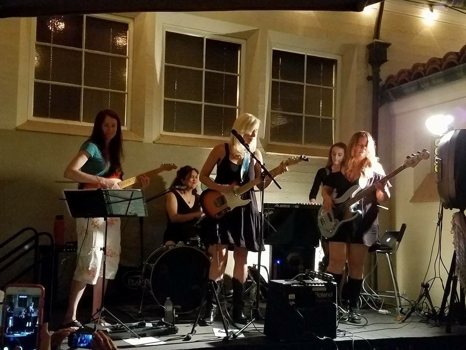 Deanne performing live with her all-mom rock band